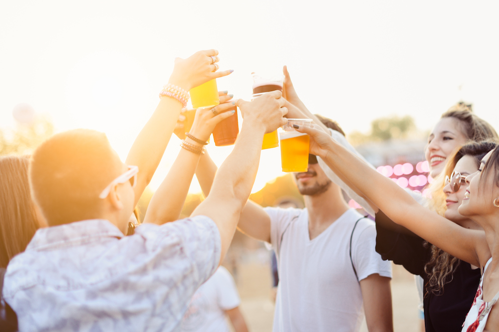 Friends toasting at music festival